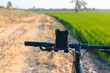 © patpitchaya - Smartphone Navigation on Bicycle in Countryside Road Travel Concept