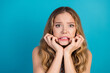 © deagreez - Young woman anxious expression biting lips against blue background for fashion lifestyle