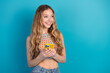 © deagreez - Young chic girl smiling while holding a yellow phone against a blue background