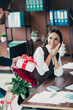 © deagreez - Businesswoman smiles at surprise gift from colleagues during office celebration in a modern loft style