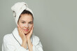 © artmim - Cute young woman with moisturizing, rejuvenating white fabric sheet mask from her face smiling at camera on white background