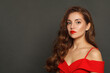 © artmim - Fashion portrait of fashion model woman with shiny skin, wavy hairstyle and red lips makeup on black background