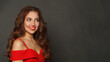 © artmim - Joyful brunette woman with trendy make-up and brown curly hair wavy hairstyle and red lips makeup on black background