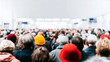 © Bonsales - Airport terminal gathering with a large crowd of people waiting in line. Travel, transit, and immigration concepts