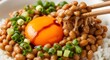 © Natsumae - Close-up of traditional Japanese natto fermented soybeans with raw egg yolk on rice