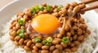 © Natsumae - Close-up of traditional Japanese natto fermented soybeans with raw egg yolk on rice