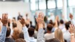 © Iuliia - People in conference raising their hands to ask a question. Audience participation and engagement at a business seminar or public meeting.