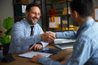 © djile - Business partners sealing deal with handshake in office