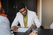 © Nuria Seguí/Stocksy - Man signs a business document