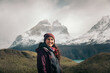 © Pedro Merino/Stocksy - Portrait of smiling traveler in Torres del Paine, Chile