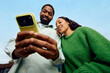 © Boris Jovanovic/Stocksy - Happy couple taking selfie outdoors
