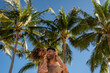 © Stephanie Tamir/Stocksy - Father and daughter under palm trees hamilton island