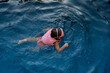 © Stephanie Tamir/Stocksy - Child swimming in blue pool water