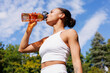 © Artem Podrez/Stocksy - Sport Woman drinking water outdoors under bright blue sky