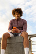 © Raymond Forbes LLC/Stocksy - Casual  Portrait black guy cell phone texting