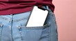© Masud - Person wearing blue jeans with white smartphone in back pocket against pink background