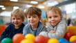 © Kateryna - Colorful portrait of three happy faceless kids posing while having fun playing in children center indoor playground recreational facility childhood joy play area bright