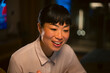 © Artcore Studio/Stocksy - Asian woman smiling and working in office at night