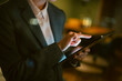 © Artcore Studio/Stocksy - Business professional hand touching tablet screen at night