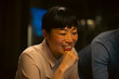 © Artcore Studio/Stocksy - Asian woman smiling during business meeting or collaboration