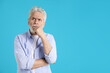 © New Africa - Amnesia. Senior man trying to remember something on light blue background, space for text