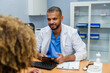 © Raul Navarro/Stocksy - Doctor discussing diagnosis with patient using digital tablet