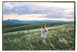 © Olly R/Stocksy - Film photo of little girl standing in the field with a mountains view