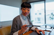 © Artcore Studio/Stocksy - Asian woman online shopping with credit card on laptop