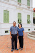 © Watcharawit Phudork/Stocksy - Adult parents taking a photo with a historical building in Bangkok