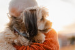 © Nuria Seguí/Stocksy - Woman hugs her dog outside