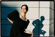 © Tania Cervian/Stocksy - Woman posing in sunlight with strong shadow