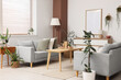 © Pixel-Shot - Interior of light living room with green plants, sofas and table