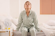 © Pixel-Shot - Mature woman experiencing menopause in bedroom