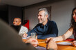 © Nuria Seguí/Stocksy - Colleagues engaged in conversation in the conference room