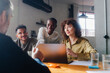 © Nuria Seguí/Stocksy - Colleagues gathered for a discussion