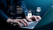 © wasan - Business professional typing on laptop with cybersecurity lock icons and login interface. Concept of data protection, online privacy, secure access, password authentication and network security.