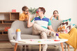 © Pixel-Shot - Father and his children in funny disguises at home. April Fool's Day celebration
