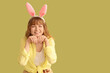 © Pixel-Shot - Young girl with Easter bunny ears on color background