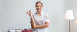 © Pixel-Shot - Portrait of beautiful female housekeeper showing OK gesture in room
