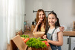 © Kawee - Portrait of Asian mother cook food with young daughter in kitchen at home.