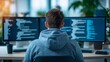 © Andrii - Empower your digital transformation: rear view of a focused developer in a hoodie working with complex code on dual monitors in a modern office, perfect for software house branding and IT blogs.