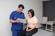 © Arlette - 14-year-old teenage girl consults a Latino doctor in his office for a check-up due to puberty and hormonal changes