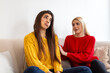 © Graphicroyalty - Young woman comforting her sad friend on the sofa. Support, empathy and friendship concept. Two females talking about problems and sharing emotions at home. Helping hand and mental health.