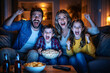 © Moddy - A happy family watching television together, enjoying popcorn and each other's company