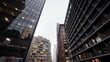 © icetray - Dramatic narrow city canyon of skyscrapers, reflective glass facades and glowing office windows at dusk, cinematic mood, rainslick street, ideal