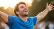 © Segera Studio - A joyful man in a blue shirt celebrating with open arms and a huge smile outdoors at sunset