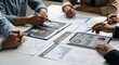 © MUGU STD - Business team analyzing financial reports and data on tablet