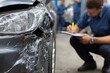 © Rifqi - Claims adjuster documenting severe damage on dark grey car bumper in repair garage, concept for insurance claims handling, auto repair quotes and collision documentation