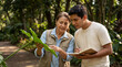 © Таня Андреева - Senior teacher and student examining a plant on a field trip.