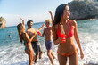 © NDABCREATIVITY - Energetic, happy young people living their best life on the beach. Full of laughter and vitality